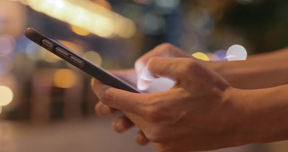 Closeup of woman hands typing on cellphone 