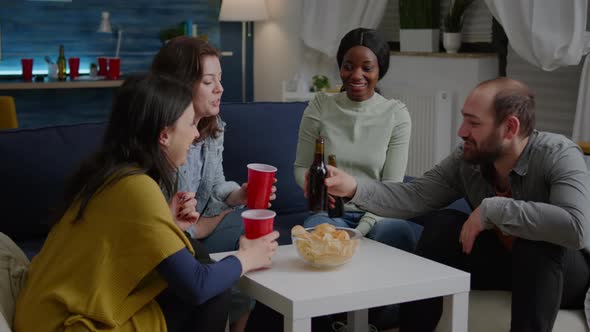 Multiethnic Friends Spending Time Together Drinking Beer During Nightlife Party