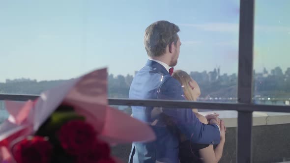 Young Couple Standing on the Terrace of the Restaurant and Talking While Watching Amazing View