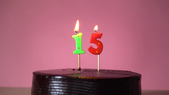 Chocolate Birthday Cake with Wick Lighting Trying to Blowout Candle