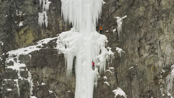 Extreme aerial showing dedicated ice climbers scaling Mount Kineo 4K