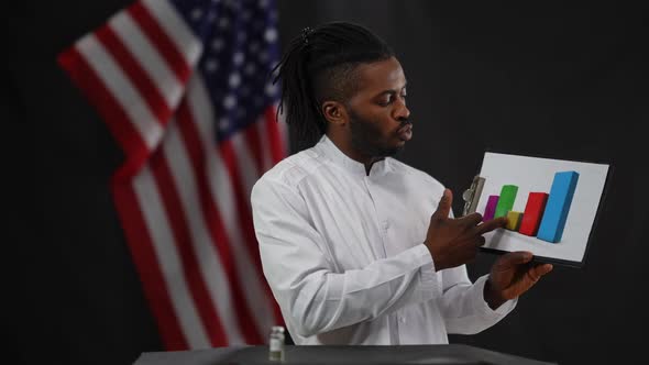 Confident Serious African American Male Doctor Presenting Drugs Efficiency at Press Conference