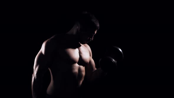 Fit and sporty bodybuilder over black background.