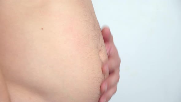 male belly, overweight. man with bare fat belly shakes fat folds on his stomach