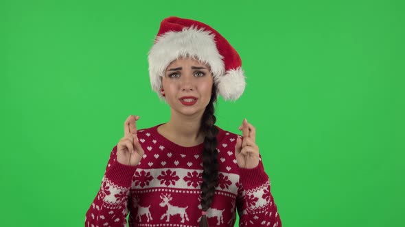 Portrait of Girl in Santa Claus Hat Is Looking at Camera with Excitement, Then Celebrating Her