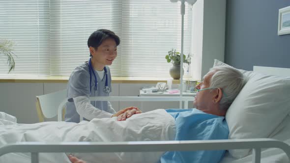 Female Doctor Supporting Senior Patient in Hospital