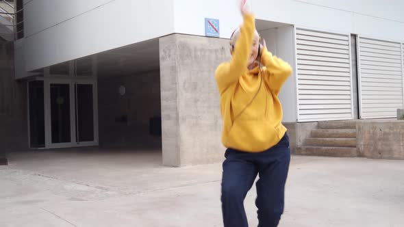 Young Alternative Woman with Short Hair Dancing Urban Dance in the Street