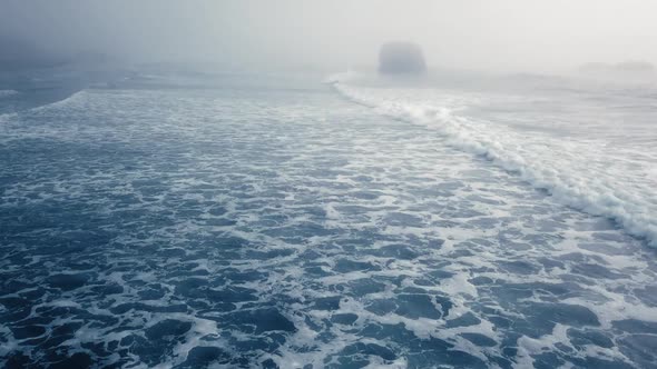 Drone view a foaming ocean wave on a foggy day (Ariya's Beach, Oregon, USA)