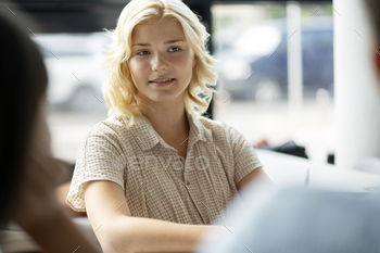 Smart school girl sitting in classroom. Teenager studying in modern library. Education concept