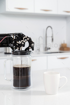 Real robot's hand and French press with black coffee. Concept of  robotic process automation