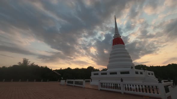 Clouds Soaring High Over The Ancient Phra Chedi Klang Nam, A Small White Beautiful Pagoda temple  In