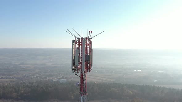 Sunset scene with telecommunication antenna repeater 4K aerial footage