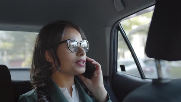 Businesswoman in Car Talking on Phone