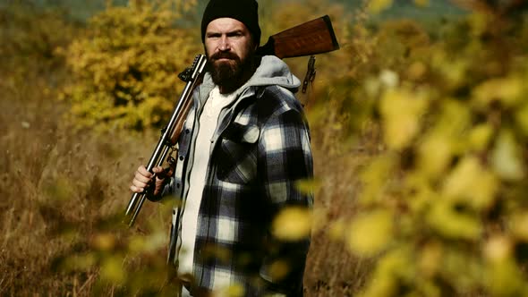 Hunter Vintage. Hunting in Russia. Hunter with a Shotgun in a Vintage Shooting Clothing.