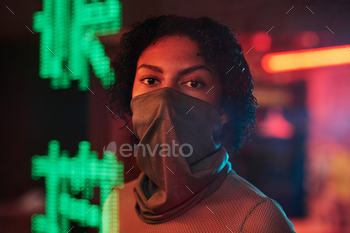 vered with mask looking at camera in cafe or bar with green hieroglyphs meaning best ramen