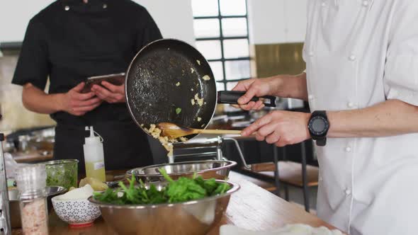 Caucasian female chef teaching diverse group