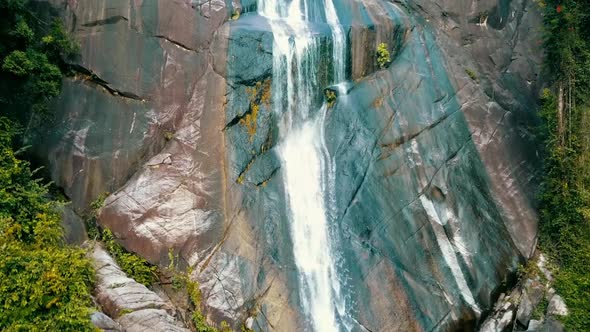 Drone shot along the falling water of the seven wells waterfall in Langkawi / Malaysia