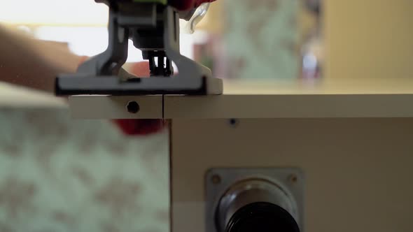 Master of Furniture Production Saws the Surface of the Table with an Electric Jigsaw.