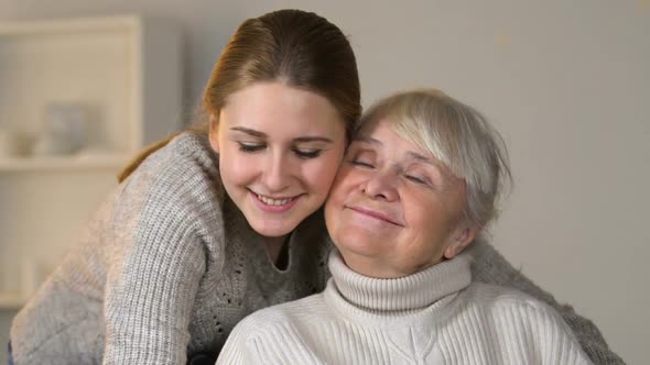 Loving Granddaughter Hugging Happy Disabled Woman in Wheelchair, Family Values