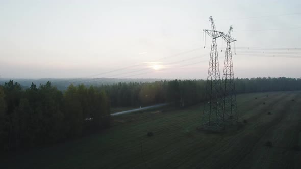 Power Line Support with High Voltage Wires in a Wooded Area