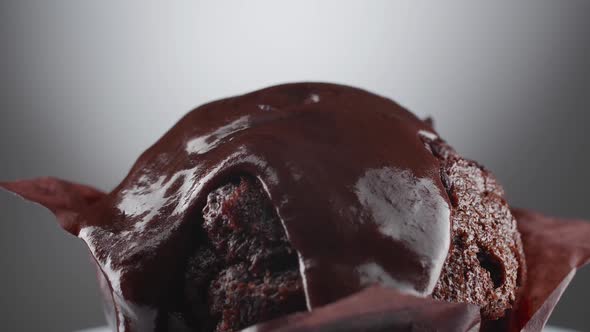 Hot melted chocolate is poured on top of the chocolate muffins.