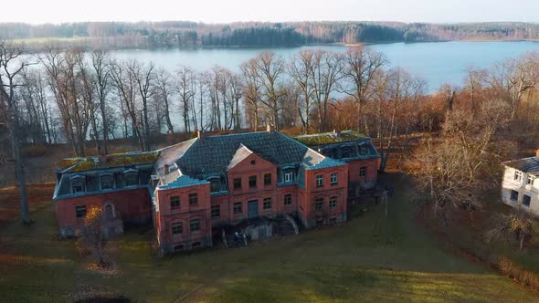 Old Red Brick House, Katvari Manor in Latvia and Katvaru Lake in the Background. Aerial Dron Shot 4K