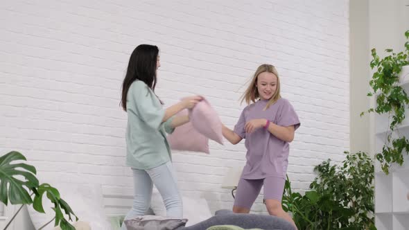 Young Girls Dancing on the Bed at Home