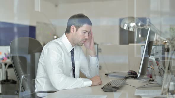 Tired Middle Aged Businessman Working on Office Computer and Having Headache