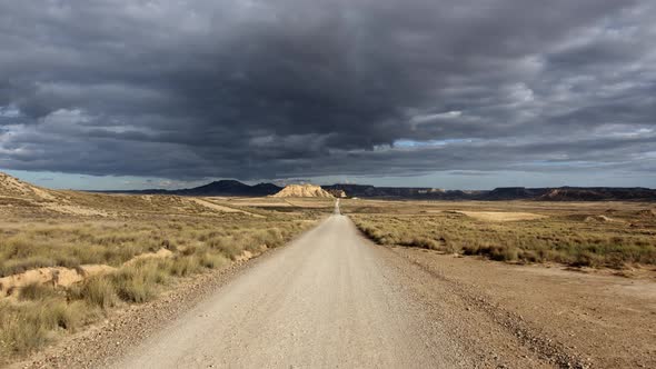 Long road in the desert under a dark sky