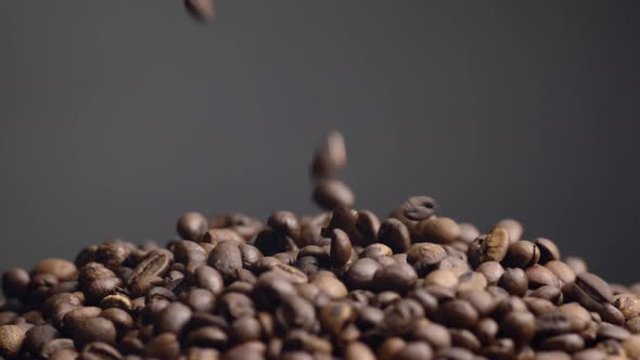 Coffee Beans Falling Down on Heap Close Up