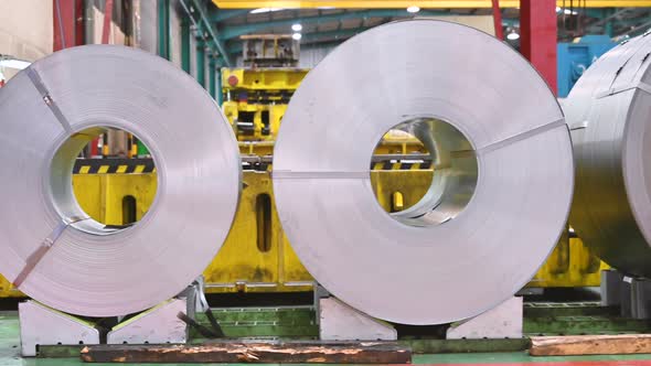 Industrial Background. Big Size Steel Coil Stored Inside Industrial Warehouse.