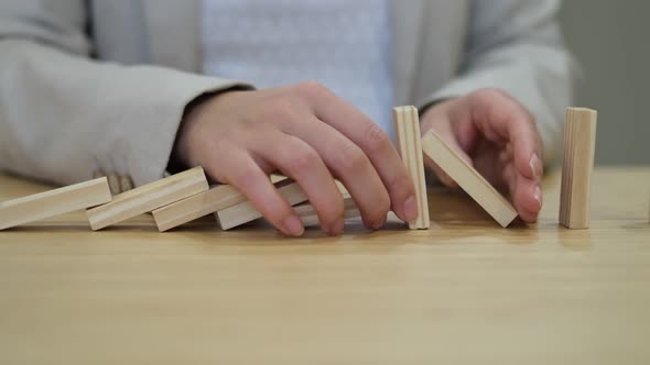 Woman Places Blocks in a Row After Falling