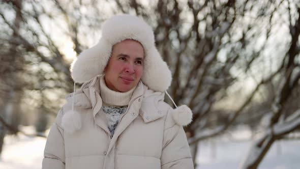 Cheerful Guy is Feeling Cold in Forest in Winter Day Walk in Nature and Breath Frosty Fresh Air