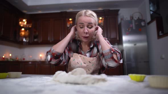 Front View Portrait of Ill or Allergic Caucasian Woman Sneezing on Dough and Flour Flying Up