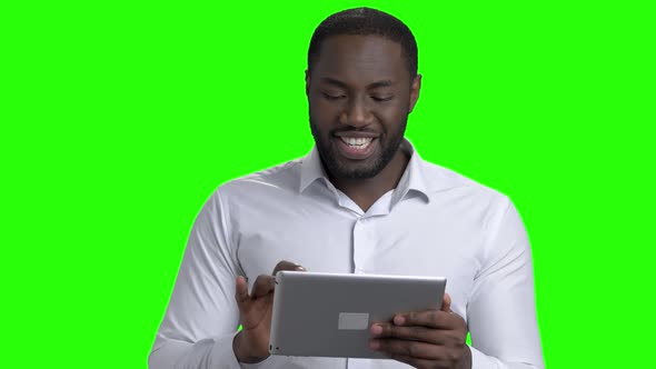 Dark-skinned Businessman Using Digital Tablet.