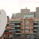 Back View of Young Woman with White Wings on Her Back Sitting on Rooftop in City - VideoHive Item for Sale