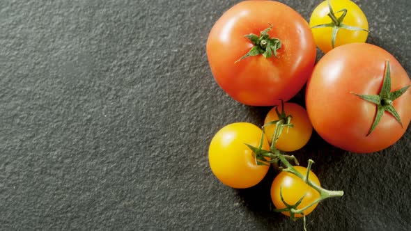 Various tomatoes arranged on grey background 4K 4k