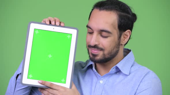 Young Happy Bearded Indian Businessman Showing Digital Tablet