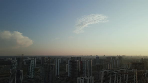 City block construction site. Multi-storey buildings. City landscape at sunrise. Aerial photography.