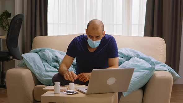 Man Wearing Mask on a Video Call with His Doctor