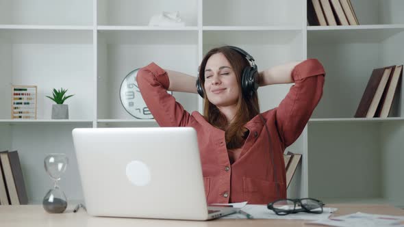 Attractive Healthy Calm Millennial Woman Relaxing on in Headphones Comfortable Chair Napping Feel