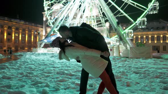 Happy Romantic Couple Playing at Ferris Wheel Background