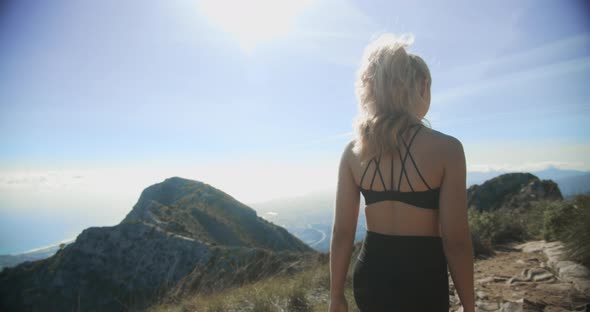 Young Blond Woman Walking In Landscape Of La Concha