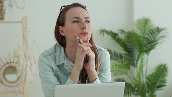 Young Woman Working Using Laptop with Hand on Chin Thinking Pensive Expression