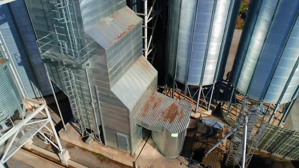 Grain warehouse, granary. Large steel towers for storing crops. Large animal feed factory.