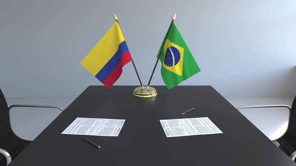 Flags of Colombia and Brazil on the Table alt