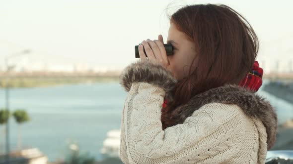 Curious Girl Is Looking Through Binoculars