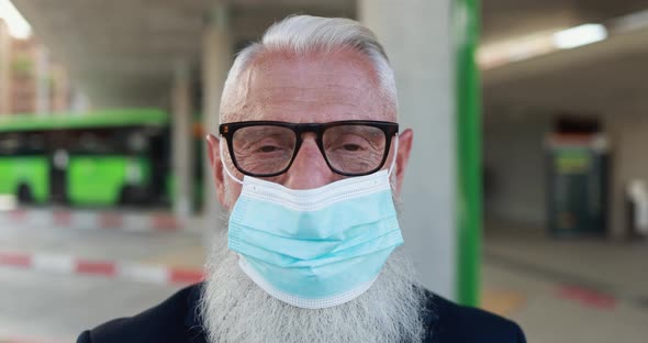 Senior business man wearing safety face mask for coronavirus outbreak