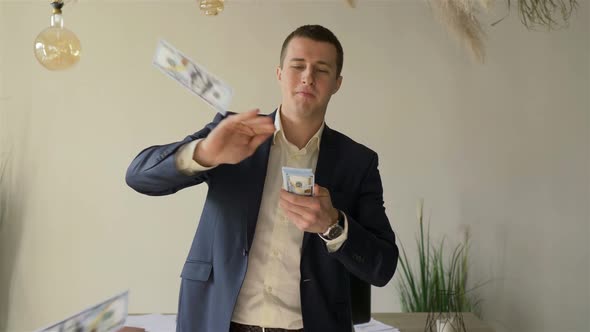 portrait of a successful businessman throwing money