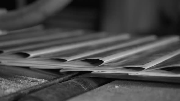 Printed Paper Newspapers Move Along the Conveyor One After Another